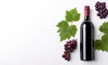 Red wine bottle on white background with ripe grapes and vine leaves. Top view. Royalty Free Stock Photo