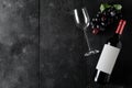 Red wine bottle with wine glass and grapes on dark wooden table flat lay from above Royalty Free Stock Photo