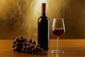 Red wine bottles with glass and grapes on wooden table and gold background Royalty Free Stock Photo