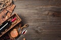 Red wine in a box with a glass, corkscrew and cream cheese on a wooden old table. Top view with space for your greetings Royalty Free Stock Photo