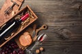Red wine in a box with a glass, corkscrew and cream cheese on a wooden old table. Top view with space for your greetings Royalty Free Stock Photo