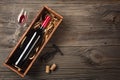 Red wine in a box with a glass and a corkscrew on a wooden table. Top view with space for your greetings Royalty Free Stock Photo