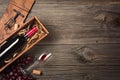 Red wine in a box with a glass and a corkscrew on a wooden table. Top view with space for your greetings Royalty Free Stock Photo