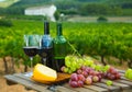 Red wine, cheese and grapes on wooden table Royalty Free Stock Photo