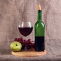 Red wine, cheeses and grapes in a still life setup. Royalty Free Stock Photo