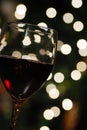 Red wine with christmas lights Royalty Free Stock Photo