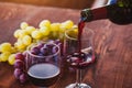 red wine closeup, pouring from bottle to glass Royalty Free Stock Photo