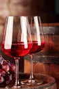 Red wine.Clsoseup of two glasses of red wine, grapes and barrel.Selective focus.Copy space Royalty Free Stock Photo