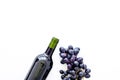 Red wine concept. Glass bottle with beverage near bunch of grapes on white background top view copy space Royalty Free Stock Photo