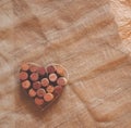 Red wine cork heart on rustic brown natural sackcloth canvas and craft paper background. Backdrop for card, bar restaurant menu, Royalty Free Stock Photo