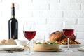 Red wine and delicious dinner served on light table Royalty Free Stock Photo