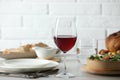 Red wine and delicious dinner served on light table Royalty Free Stock Photo