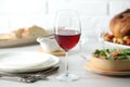 Red wine and delicious dinner served on light table Royalty Free Stock Photo