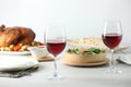 Red wine and delicious dinner served on light table Royalty Free Stock Photo