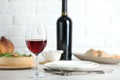 Red wine and delicious dinner served on light table Royalty Free Stock Photo