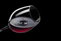 red wine drop falling in glass and created splash Royalty Free Stock Photo