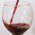 Red wine flow into glass macro