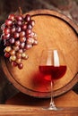 Red wine.Glas of red wine, grapes and barrel.Selective focus.Copy space Royalty Free Stock Photo