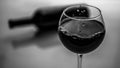 Red wine in a glass black and white picture, a bottle of wine with a glass of wine. Royalty Free Stock Photo