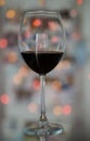 Red wine glass on a bokeh background