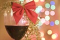 Red wine in glass with christmas tinsel