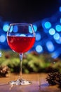 Red wine in a glass. Concept of Happy Christmas, New Year, Winter, Greeting, Holiday, Alcohol. Royalty Free Stock Photo