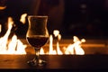 Red Wine Glass with Cozy Fire Behind It