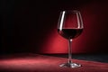 Red wine glass in a dark scene with red background - generated by ai Royalty Free Stock Photo