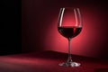 Red wine glass in a dark scene with red background - generated by ai Royalty Free Stock Photo
