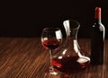 Red wine in glass, decanter and bottle on table