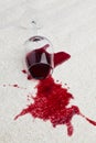 Red wine glass dirty carpet. Royalty Free Stock Photo