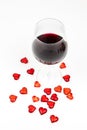 Red wine glass and red hearts isolated on white background - romantic seduction - valentines day Royalty Free Stock Photo