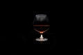 Red wine in a glass isolated on black background - realistic photo image