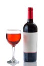 Red Wine in Glass next to full bottle on white background Royalty Free Stock Photo