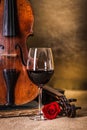 Red wine in glass and old violin Royalty Free Stock Photo