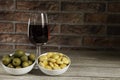 Red wine glass, olives bowl and lupins bowl Royalty Free Stock Photo