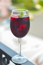 Red wine glass outside. Selective focus on glass, blurred background. Fruit alcohol drink for hot summer weather Royalty Free Stock Photo