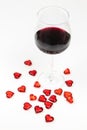 Red wine glass and red hearts isolated on white background - romantic seduction - valentines day Royalty Free Stock Photo