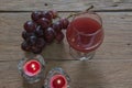 Red wine in glass for a romantic and candle on wooden table. Royalty Free Stock Photo