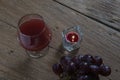 Red wine in glass for a romantic and candle on wooden table. Royalty Free Stock Photo