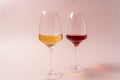 Red wine glass and rose wine glass on pink background