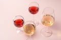 Red wine glass and rose wine glass and white wine glass on pink background Royalty Free Stock Photo