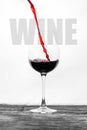 Red wine in the glass splashes in motion on a white background. Design card with text Royalty Free Stock Photo