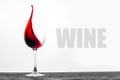 Red wine in the glass splashes in motion on a white background. Design drink card with text Royalty Free Stock Photo