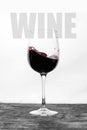 Red wine in the glass splashes in motion on a white background. Stylish design card with text Royalty Free Stock Photo