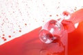 Red wine and glass splashing on background