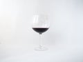 Red wine in a glass on white background