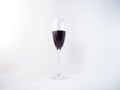 Red wine in a glass on white background