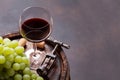 Red wine glass and white grape on old barrel Royalty Free Stock Photo