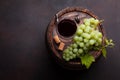 Red wine glass and white grape on old barrel Royalty Free Stock Photo